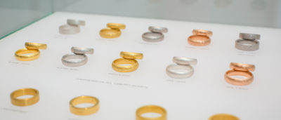 verschiedene Eheringe mit unterschiedlichen Oberflächen in Schmuckvitrine