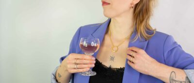 Frau mit Lila Blazer trägt gedrehter ring gold aus der Schmuck Kollektion Twister aus Fairtrade Gold von Jan Spille aus Hamburg Altona